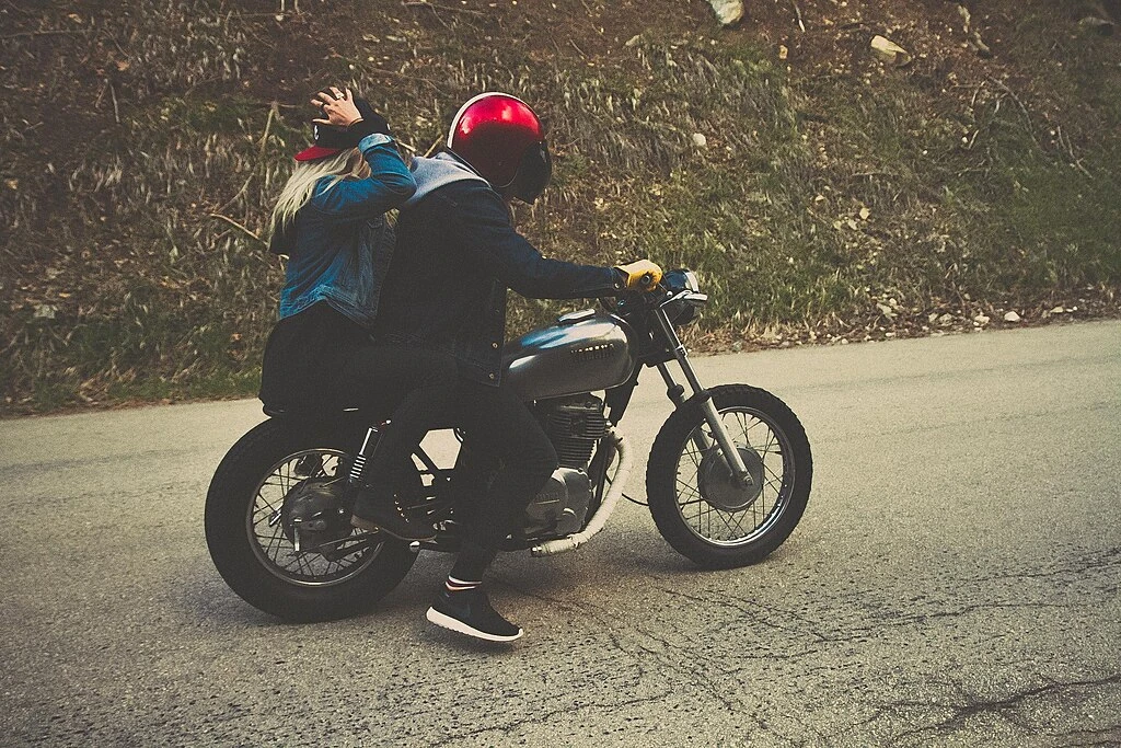 Two people on one seat of motorcycle - Header Image