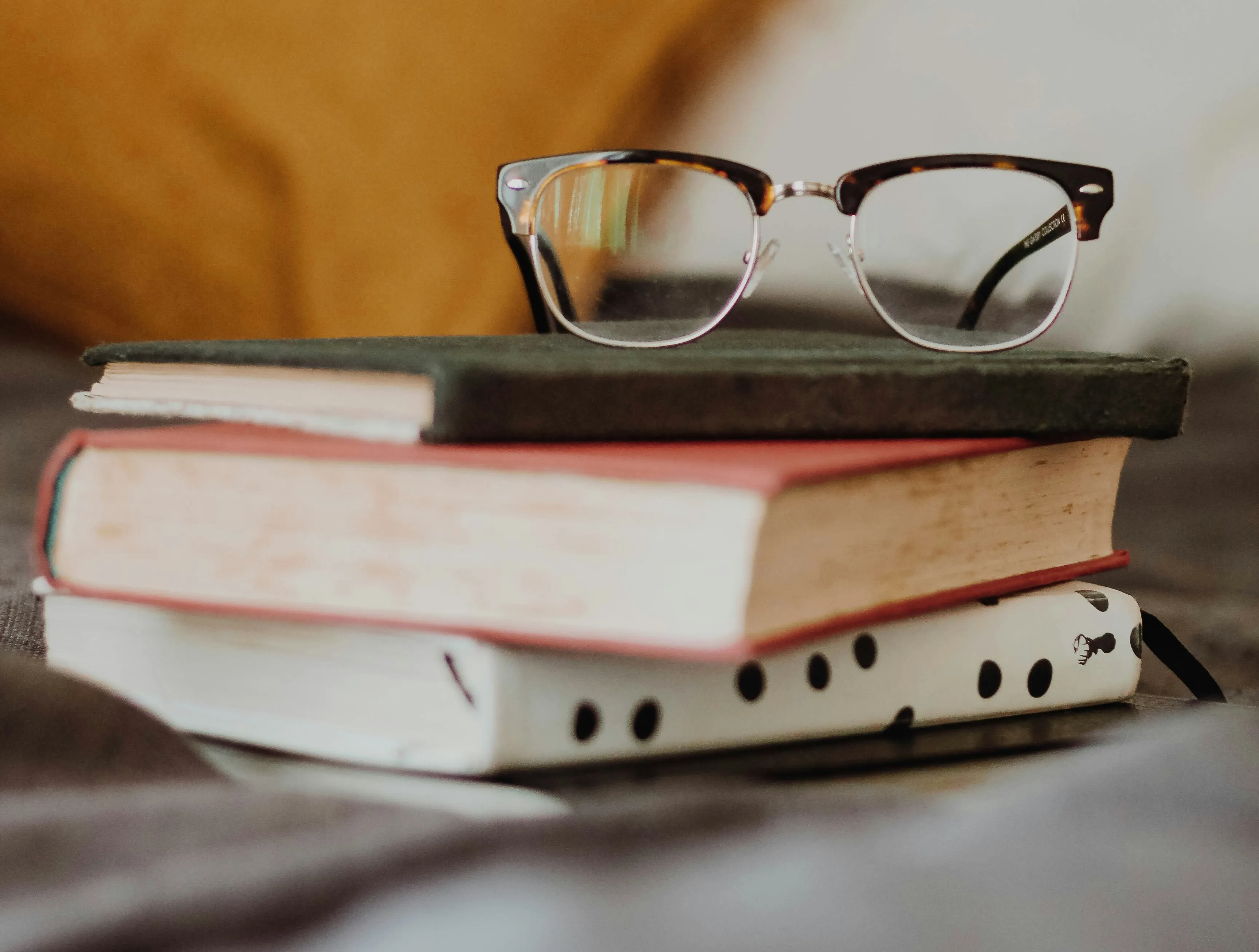 glasses on top of books